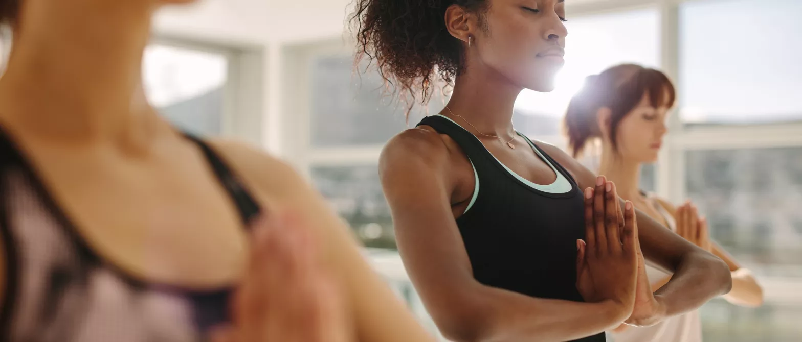 Three women in a yoga class