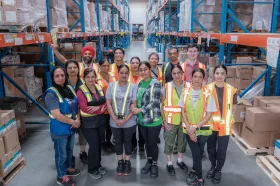Group of smiling workers in a warehouse