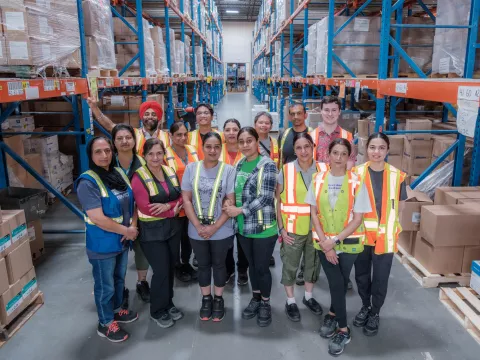 Group of smiling workers in a warehouse