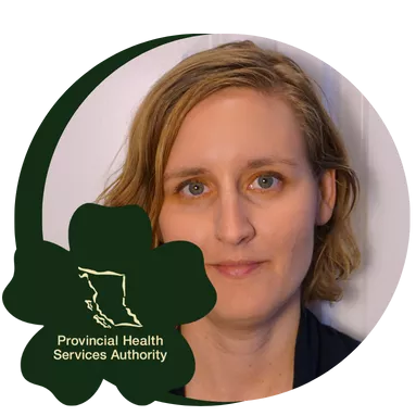 A person with short, wavy blonde hair and blue eyes