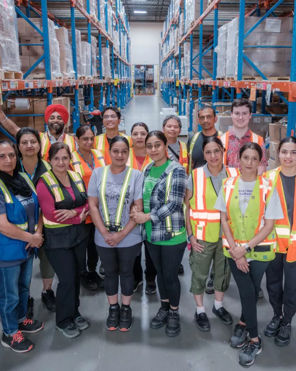 Group of smiling workers in a warehouse