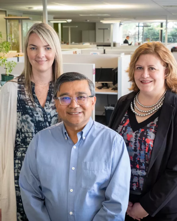 Three smiling people